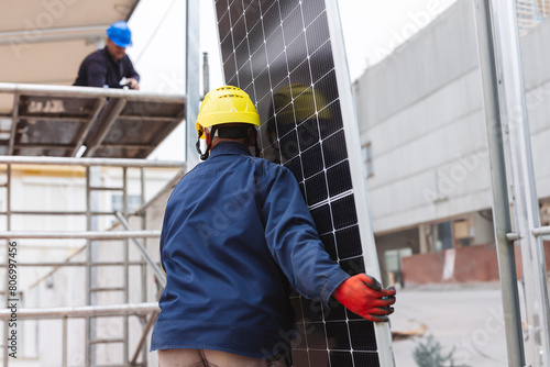 engineer man carrying a solar panel