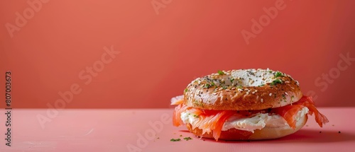Relish the taste of a New Yorkstyle bagel, generously topped with cream cheese and salmon, with a solid background and copy space on center for advertise photo