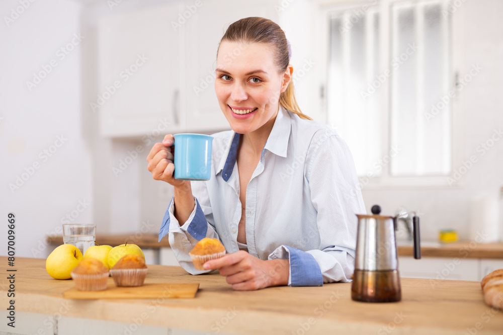 Positive woman having breakfast, drinking coffee Positive woman having breakfast, drinking coffee