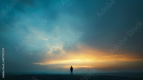 Person standing alone in prayer as the sky transitions during the twilight of Yom Kippur