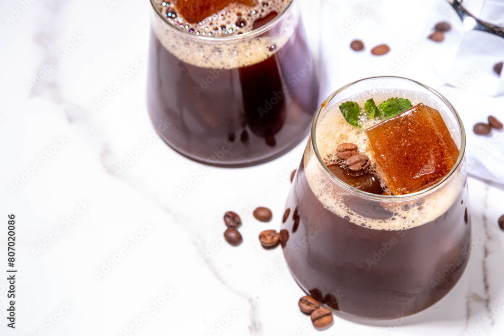 Cold Brew Coffee Espresso Carajillo Cocktail with frozen espresso ice cubes, strong black coffee, liqueur and Vodka, on white kitchen table background copy space Cold Brew Coffee Espresso Carajillo Cocktail with frozen espresso ice cubes, strong black coffee, liqueur and Vodka, on white kitchen table background copy space