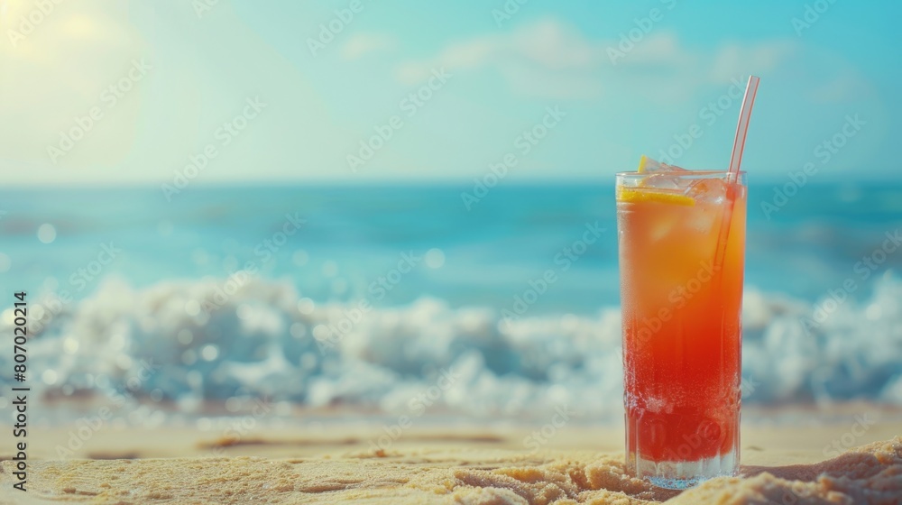 Obraz premium Refreshing summer drink with beach backdrop.