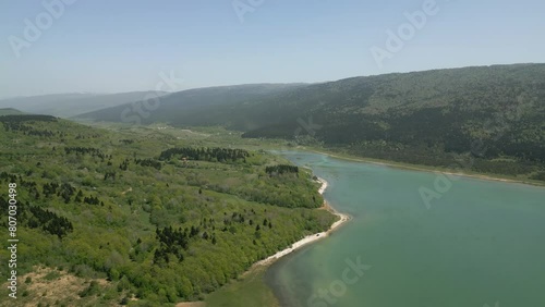 bulk dam near a mountain lake, abandoned tower in the water, aerial view photo