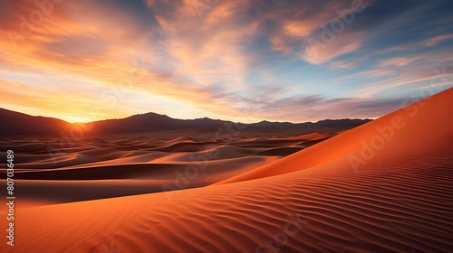 Desert sand dunes at sunset. Panoramic view.