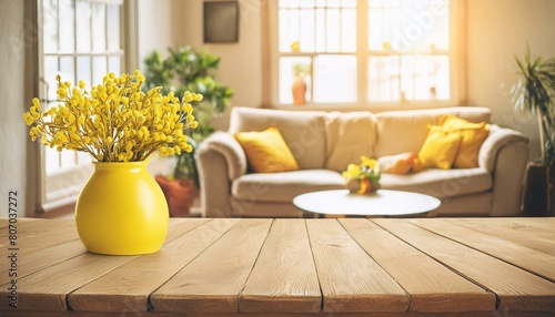 yellow flowers in a vase, cozy home interior beige wooden table with yellow vase basking in the warm sunligh photo