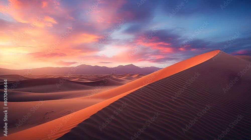 Panoramic view of sand dunes in the desert at sunset