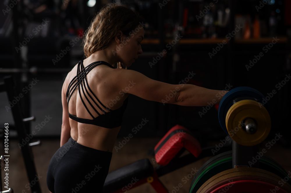 Fototapeta premium Middle aged woman posing in the gym. 