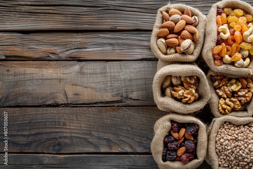 Raw organic nuts and dried fruits on rustic wooden background, natural snacks