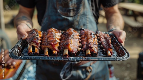 A barbecue enthusiast proudly displaying a tray of competition-worthy pork ribs, perfectly cooked and ready for judging at a BBQ cook-off.