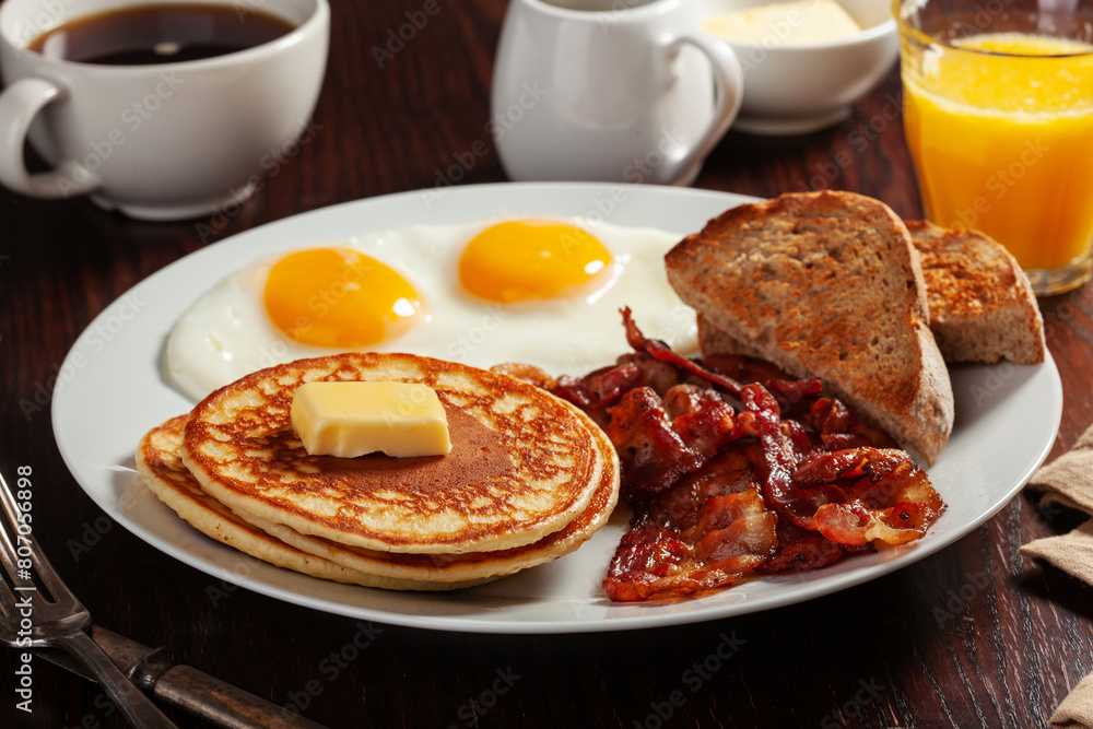 traditional full american breakfast eggs pancakes with bacon and toast
