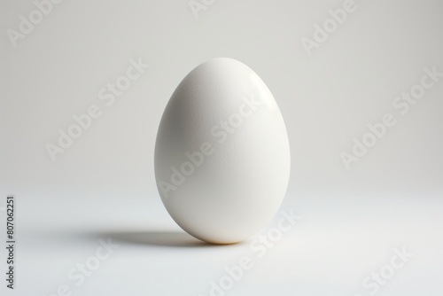 A solitary egg standing upright against a clean, white background symbolizing simplicity and new beginnings
