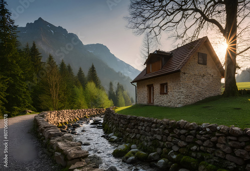 cottage by a stream with mountains in the background