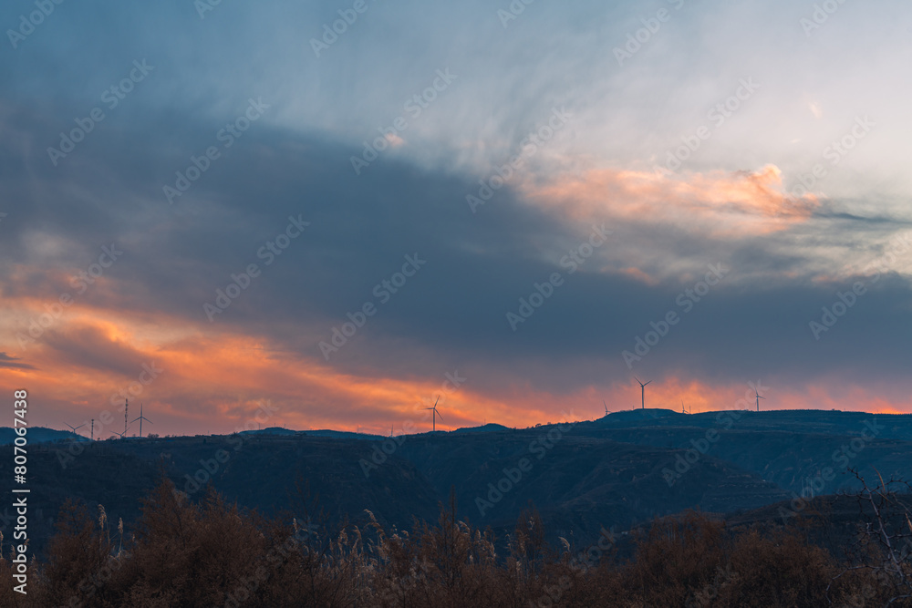 Fire clouds burn under windmills along the Yellow Highway in Yan'an City, Shaanxi Province Fire clouds burn under windmills along the Yellow Highway in Yan'an City, Shaanxi Province