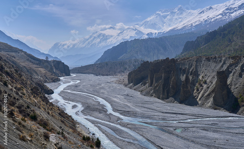 Panorama on the wide valley of the river Khangsar Khola with ice capped mountains in the background. Trek to Tilicho Lake, Annapurna Circuit, Nepal. High altitude mountain trek.