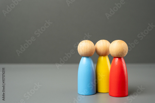 Three colored figures of people. Contact, communication and spending time. A team of people with different skills. Unity and work in teamwork. Recruiting new workers.