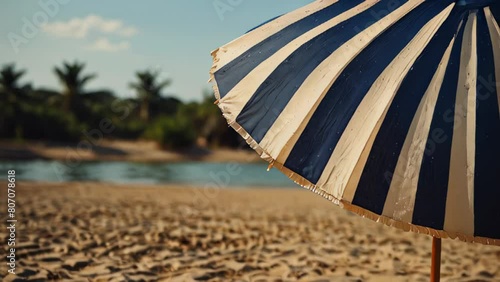 A beach umbrella is open on a sandy beach