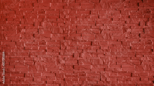 abstract stone cladding wall made of regular bright red bricks. abstract wall panels for decoration  background and texture. red wall made from grunge stone material for modern style decoration.