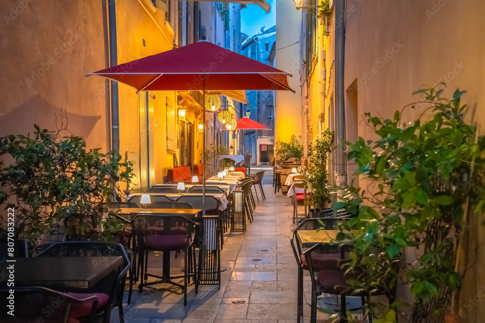 Saint Tropez stone alley with restaurants evening view, luxuty travel destination