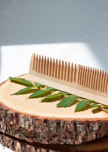 a wooden comb in front of a white wall
