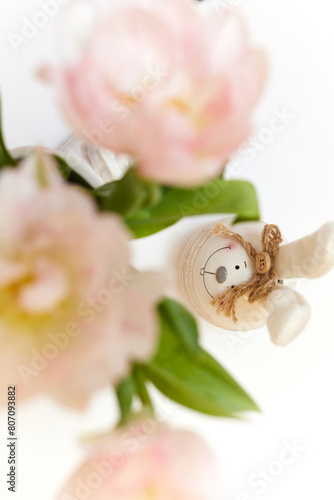 bouquet of tulips and Easter bunny on white table. copy space