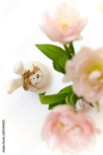 bouquet of tulips and Easter bunny on white table. copy space