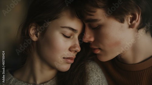 Couple faces each other head against head eye closed nose against nose Caucasian male and female hugging