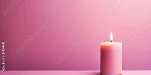 Pink background with white thin wax candle with a small lit flame for funeral grief death dead sad emotion with copy space texture for display 