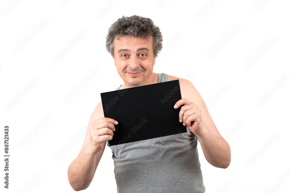 A shaggy gray-haired middle-aged man with stubble in a sleeveless T-shirt holds a black sign without an inscription in his hands A shaggy gray-haired middle-aged man with stubble in a sleeveless T-shirt holds a black sign without an inscription in his hands