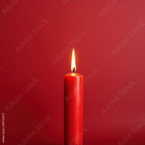 Red background with white thin wax candle with a small lit flame for funeral grief death dead sad emotion with copy space texture for display products 