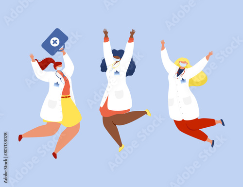 Three female doctors in white coats and protective masks are jumping and celebrating on a blue background.