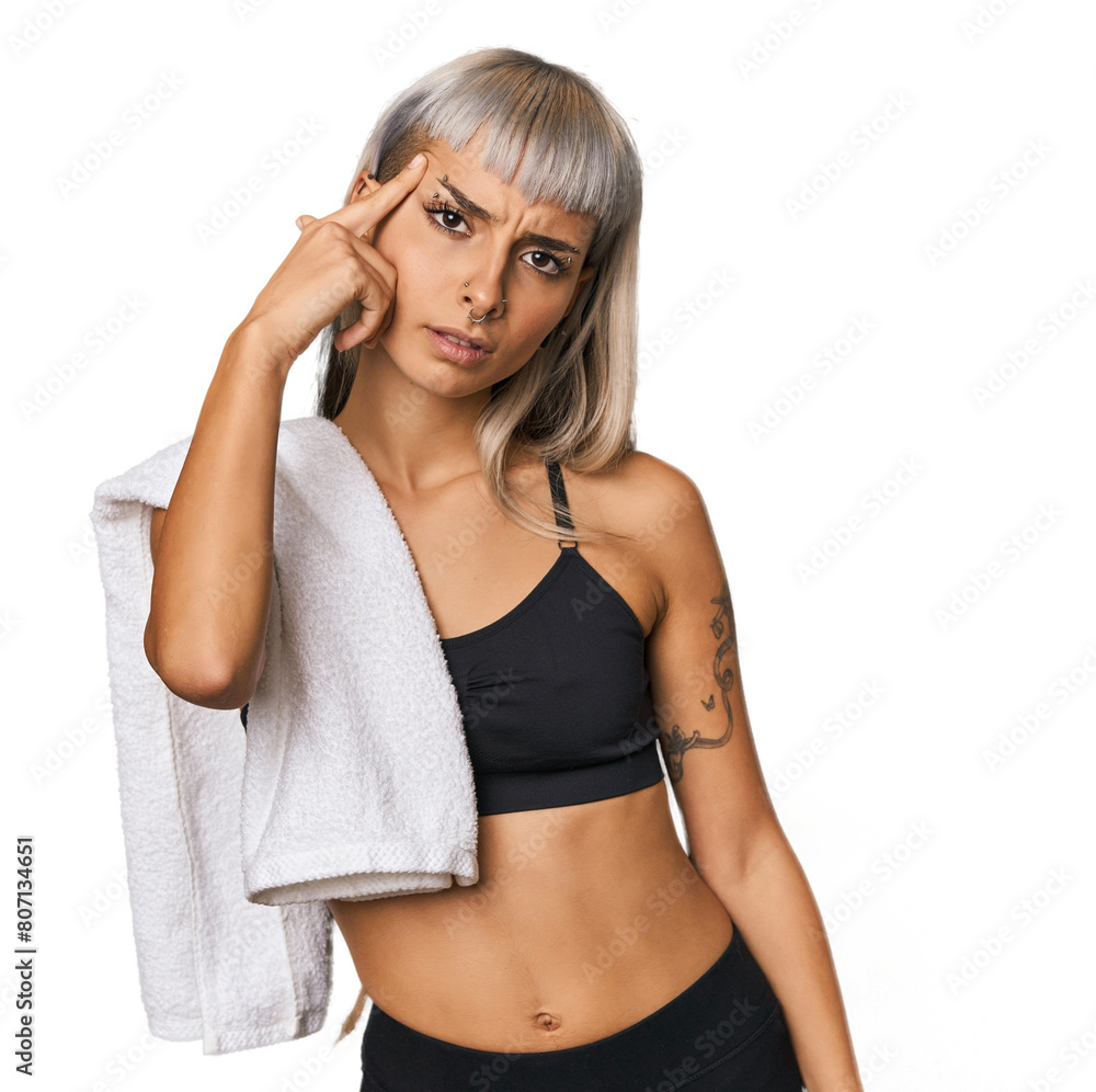 Caucasian young woman in sportswear showing a disappointment gesture with forefinger. Caucasian young woman in sportswear showing a disappointment gesture with forefinger.