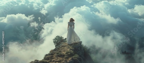 Woman model stands on a cliff in a white dress and clouds envelop her below. AI generated image photo