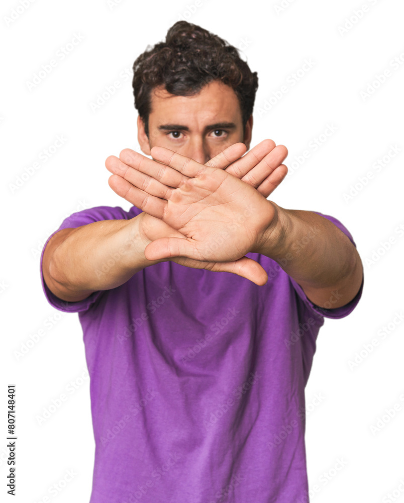 Young Hispanic man in studio doing a denial gesture Young Hispanic man in studio doing a denial gesture