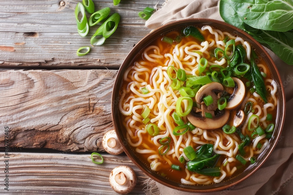 Top view of delicious noodle soup with mushrooms and bok choy in a bowl on the table Top view of delicious noodle soup with mushrooms and bok choy in a bowl on the table