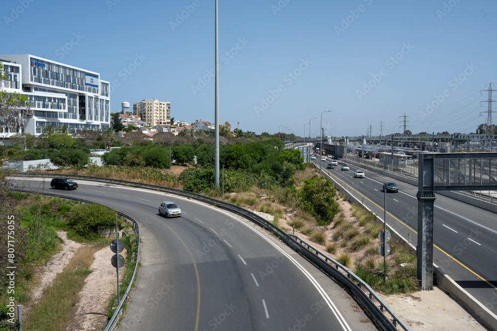 Cars entering the Ayalon highway, in Herzliya, Israel, with clear blue sky. Cars entering the Ayalon highway, in Herzliya, Israel, with clear blue sky.