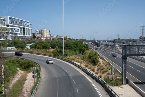 Cars entering the Ayalon highway, in Herzliya, Israel, with clear blue sky. photo