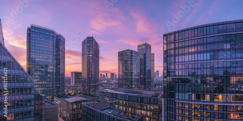 The image showcases a breathtaking view of a city skyline with skyscrapers bathed in the warm glow of a sunset  reflecting off the buildings  glass facades