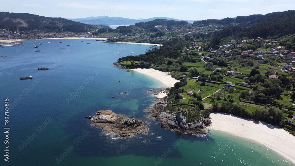 Fototapeta premium Coastal Serenity: Aerial View of Tranquil Beaches, Transparent Waters, Rocky Shoreline, and Lush Vegetation from Ocean Perspective 
