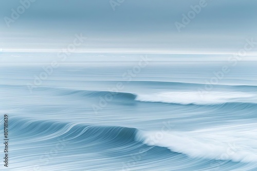 Abstract aerial panorama of ocean waves, captured with a long exposure to create a smooth, dreamlike surface, complemented by expansive sky for copy