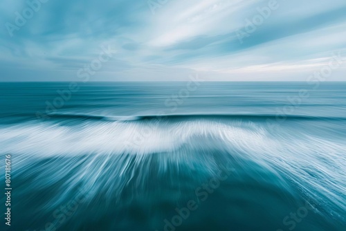 Abstract aerial panorama of ocean waves  captured with a long exposure to create a smooth  dreamlike surface  complemented by expansive sky for copy