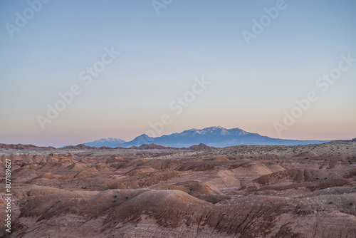 Gorgeous Desert Hills in Goblin Valley Utah Snow Capped Mountains Sunset