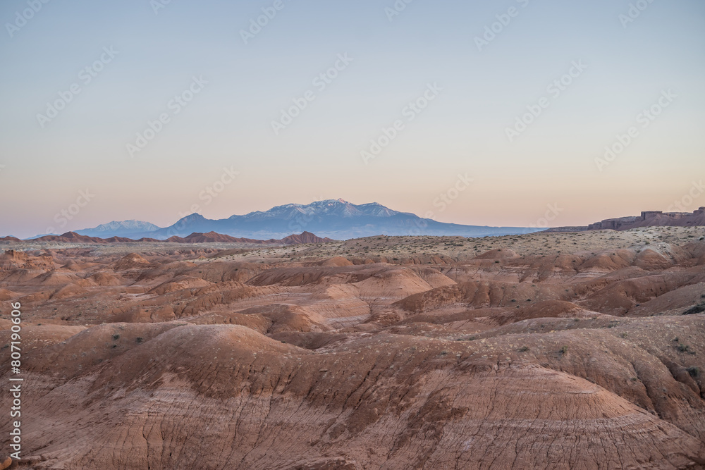 Gorgeous Desert Hills in Goblin Valley Utah Snow Capped Mountains Sunset Gorgeous Desert Hills in Goblin Valley Utah Snow Capped Mountains Sunset