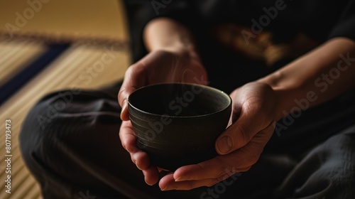 Solo traveler at a Japanese tea ceremony, close-up on hands holding a delicate tea bowl, serene setting 