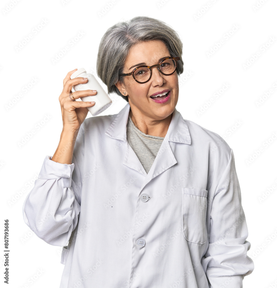 Middle-aged Caucasian female pharmacist with pills Middle-aged Caucasian female pharmacist with pills