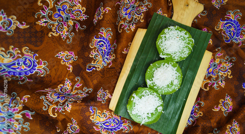 Kue Lumpang Ijo (Pandan Sticky Rice Cakes) is Indonesian traditional dessert made from screwpine leaves and glutinous flour with shredded coconut as a topping  photo