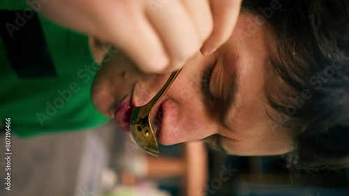 vertical video close up At a coffee roasting factory in the kitchen a tester uses a spoon to taste the coffee photo