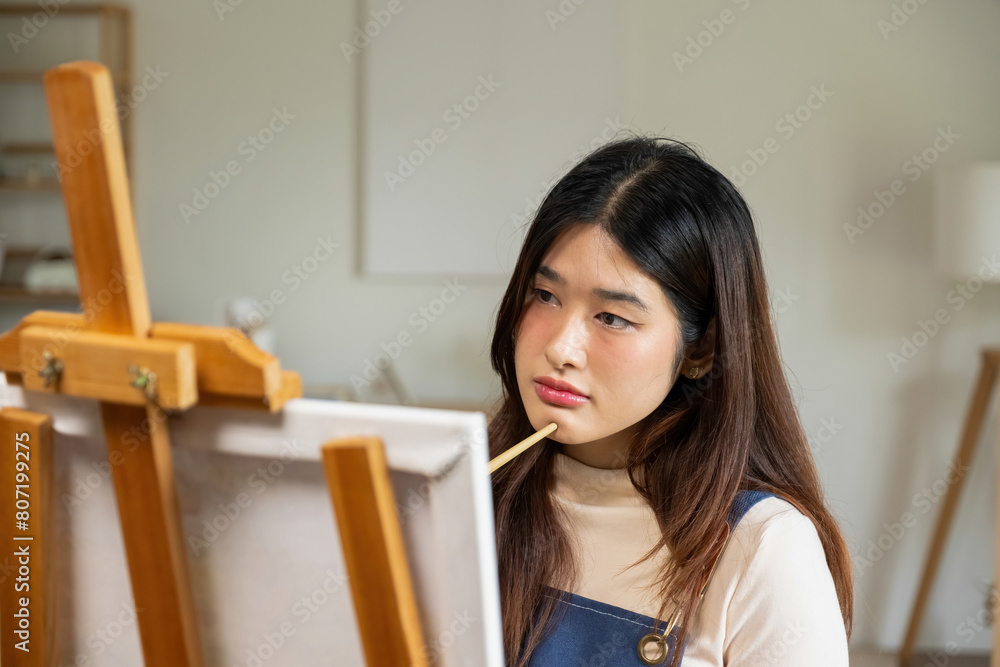 The creative person stood in his studio, lost in concentration as he worked on his latest painting. The creative person stood in his studio, lost in concentration as he worked on his latest painting.