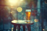 Glass of beer on a wooden table in a cafe with bokeh background