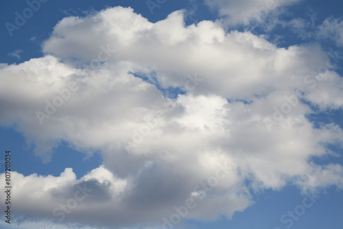 white cloud in the blue sky, illuminated by sunlight