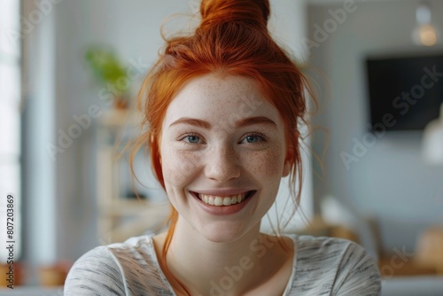 Joyful redhead woman celebrates good news indoors.